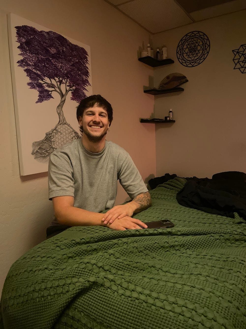 Isaac Clipper beside the massage table in his Chico studio